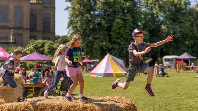 Kids jumping around the haybales at Hardwick's Summer of Play